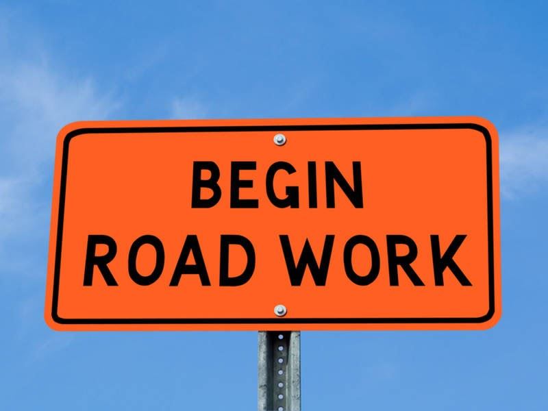 road construction begin road work sign